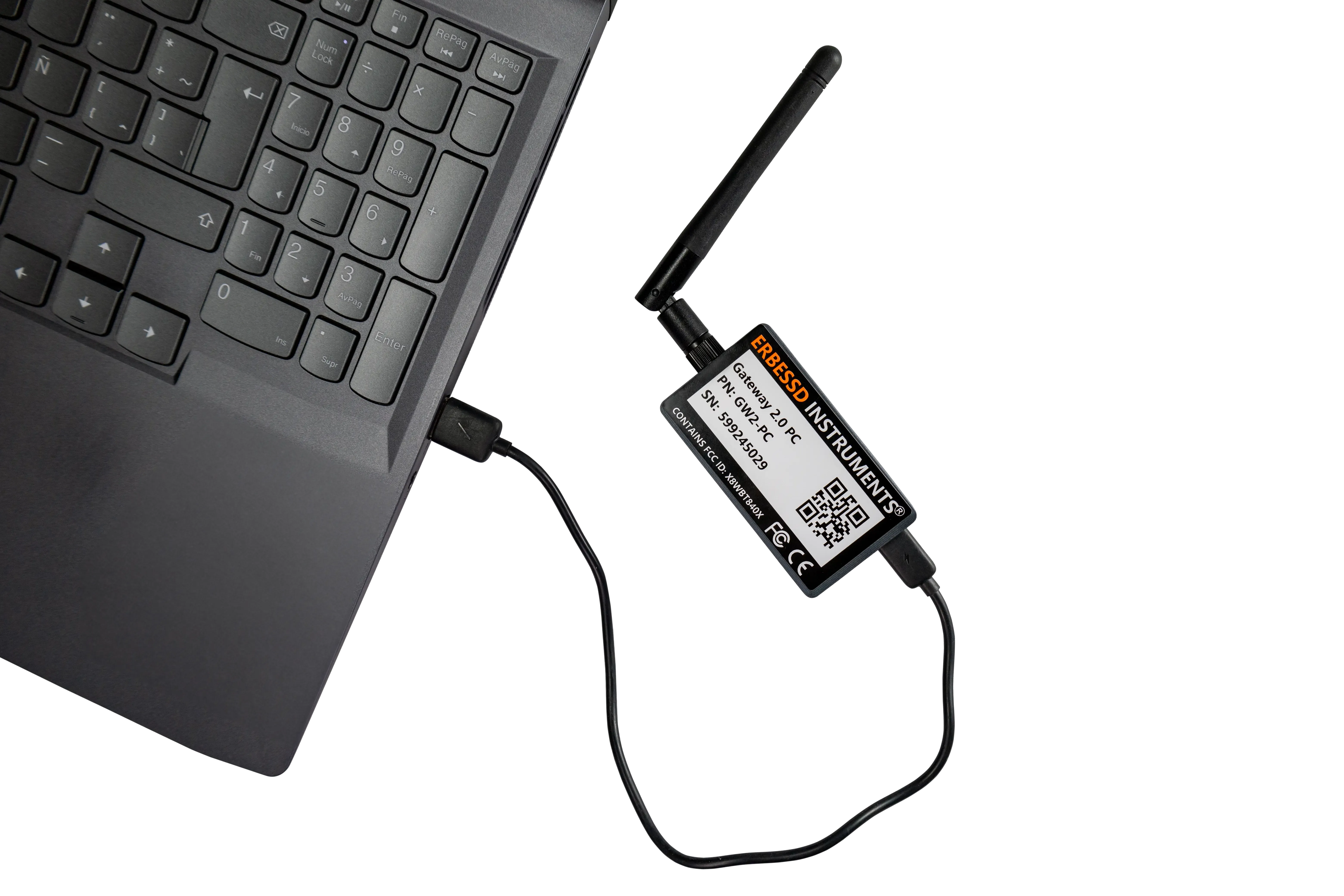 PHANTOM® USB Gateway with its antenna, connected by cable to the USB port of a laptop.