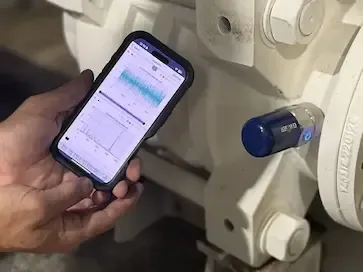 Vibration measurement taken with the mobile app next to a wireless sensor mounted on the equipment.